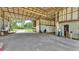 Open barn interior with concrete floors, high ceilings, offering lots of potential storage space at 1309 Joe Mcintosh Rd, Plant City, FL 33565