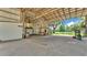 Barn interior featuring a high ceiling, wooden beams, ample space, and natural light at 1309 Joe Mcintosh Rd, Plant City, FL 33565