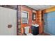 Rustic bathroom with wood paneling, stone accents, toilet, shower and vanity with dark finish at 1309 Joe Mcintosh Rd, Plant City, FL 33565