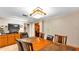 Dining room featuring a table, chairs, a TV on a bureau, and a decorative light fixture at 1309 Joe Mcintosh Rd, Plant City, FL 33565
