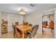 Traditional dining room featuring tile flooring, a decorative light fixture, and a wooden table with six chairs at 1309 Joe Mcintosh Rd, Plant City, FL 33565