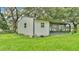 Exterior view of a metal barn with a screened in porch and a grassy lawn surrounding the building at 1309 Joe Mcintosh Rd, Plant City, FL 33565