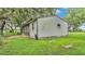 The backyard has a metal building with a screen porch and is surrounded by lush green lawn at 1309 Joe Mcintosh Rd, Plant City, FL 33565