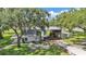 Exterior angle of the side of the house, with a barn on an expansive property surrounded by mature trees at 1309 Joe Mcintosh Rd, Plant City, FL 33565