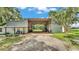 Exterior shot of a barn or garage-type building adjacent to a home at 1309 Joe Mcintosh Rd, Plant City, FL 33565