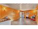 Bright living area with wood paneling, tile floors, a kitchenette, and natural light from the door and window at 1309 Joe Mcintosh Rd, Plant City, FL 33565