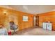 Cozy living area featuring wood paneled walls, tile flooring, a window, and a kitchenette at 1309 Joe Mcintosh Rd, Plant City, FL 33565