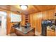 Office featuring wood-paneled walls, a desk, a whiteboard, and a storage unit at 1309 Joe Mcintosh Rd, Plant City, FL 33565