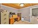 Functional office space with a wooden desk, filing cabinets, and a door leading to the outside at 1309 Joe Mcintosh Rd, Plant City, FL 33565