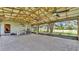 The spacious screened outdoor patio features pavers, a wood beam roof, and ceiling fans at 1309 Joe Mcintosh Rd, Plant City, FL 33565