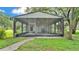 A beautifully screened outdoor patio featuring a full outdoor kitchen and ceiling fans at 1309 Joe Mcintosh Rd, Plant City, FL 33565