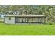 Charming screened porch providing an indoor-outdoor living space and relaxing views of the green lawn at 1309 Joe Mcintosh Rd, Plant City, FL 33565