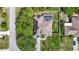 Aerial view of the property featuring a screened pool, solar panels, and a spacious yard at 173 Portland Ave, Spring Hill, FL 34606
