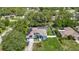 Charming home with a fenced yard, solar panels, and a screened-in pool, nestled among lush trees at 173 Portland Ave, Spring Hill, FL 34606