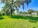 Well-maintained backyard with lush grass and mature trees, offering a serene outdoor setting at 173 Portland Ave, Spring Hill, FL 34606