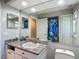 Bathroom featuring granite countertops, large mirror, and marine themed shower curtain at 173 Portland Ave, Spring Hill, FL 34606