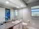 Bright bathroom featuring vanity with granite countertop, large mirror and good lighting at 173 Portland Ave, Spring Hill, FL 34606
