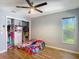 Bright bedroom featuring a ceiling fan, closet and window providing natural light at 173 Portland Ave, Spring Hill, FL 34606