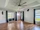 Spacious main bedroom with hardwood flooring, a ceiling fan, and sliding glass door at 173 Portland Ave, Spring Hill, FL 34606