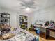 Bedroom with light walls, wood floor, ceiling fan, and closet space at 173 Portland Ave, Spring Hill, FL 34606