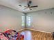 Cozy bedroom featuring wood-look flooring and a modern ceiling fan at 173 Portland Ave, Spring Hill, FL 34606