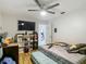 This bedroom features a ceiling fan and a mounted television for a comfortable and entertaining space at 173 Portland Ave, Spring Hill, FL 34606