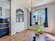 Bright dining area featuring hardwood floors, large windows, and decorative archway at 173 Portland Ave, Spring Hill, FL 34606
