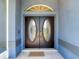 Elegant double front doors with decorative glass and a welcoming doormat at 173 Portland Ave, Spring Hill, FL 34606