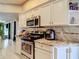 Well-equipped kitchen with stainless steel appliances, granite countertops, and white cabinetry at 173 Portland Ave, Spring Hill, FL 34606
