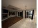 Cozy living room with a stone fireplace, hardwood floors, and sliding glass doors at 173 Portland Ave, Spring Hill, FL 34606