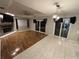 Spacious living room featuring hardwood flooring, a cozy fireplace, and sliding glass doors at 173 Portland Ave, Spring Hill, FL 34606