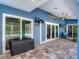 Covered patio with ceiling fan, TV, and tile flooring, offering an ideal outdoor living space at 173 Portland Ave, Spring Hill, FL 34606