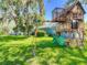 Wooden playhouse with swing set and climbing area in the backyard at 173 Portland Ave, Spring Hill, FL 34606