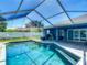 Inviting pool and spa combo under a screened enclosure with extended patio area at 173 Portland Ave, Spring Hill, FL 34606