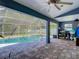 Screened pool area with tiled patio and covered outdoor space at 173 Portland Ave, Spring Hill, FL 34606