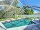 Relaxing screened pool with a brick deck, perfect for enjoying the outdoors in privacy at 173 Portland Ave, Spring Hill, FL 34606