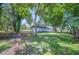 Spacious backyard featuring lush greenery and mature trees surrounding the home at 2633 Keysville Dr, Lithia, FL 33547