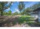 View of the expansive backyard featuring green grass and shady trees at 2633 Keysville Dr, Lithia, FL 33547