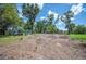 A large backyard with partial grass coverage and large trees at 2633 Keysville Dr, Lithia, FL 33547