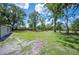 Expansive grassy backyard shaded by mature trees, offering ample space at 2633 Keysville Dr, Lithia, FL 33547
