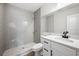 Stylish bathroom featuring a tiled shower, modern vanity, and elegant fixtures at 2633 Keysville Dr, Lithia, FL 33547