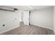 Another bedroom showcasing modern gray flooring, neutral paint, and closet with shelving at 2633 Keysville Dr, Lithia, FL 33547