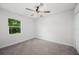 Clean bedroom with carpet, ceiling fan and view to the yard at 2633 Keysville Dr, Lithia, FL 33547