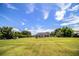 Vast backyard with mature trees, a utility shed, horse pen, and open lawn, ideal for outdoor activities at 3730 Ralston Rd, Plant City, FL 33566