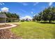 Spacious backyard with lush green grass and mature trees at 3730 Ralston Rd, Plant City, FL 33566