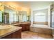 Bright bathroom showcasing a soaking tub, and tiled flooring at 3730 Ralston Rd, Plant City, FL 33566