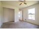 This bedroom has neutral walls, carpet, ceiling fan and a window at 3730 Ralston Rd, Plant City, FL 33566
