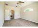 Spacious bedroom with carpet, a ceiling fan, and an arched window letting in natural light at 3730 Ralston Rd, Plant City, FL 33566