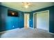 This bedroom has blue walls, carpet and a ceiling fan at 3730 Ralston Rd, Plant City, FL 33566