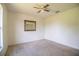 This bedroom has neutral walls, carpet, ceiling fan and a decorative mirror at 3730 Ralston Rd, Plant City, FL 33566